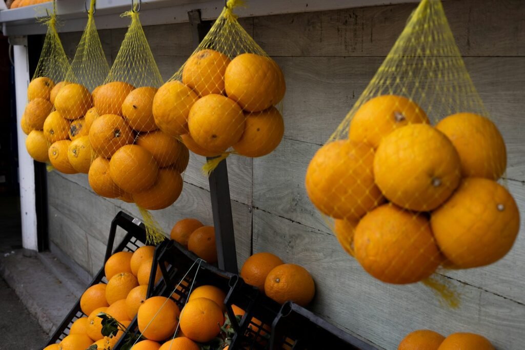 Natural Diet, a bunch of oranges that are hanging from a wall